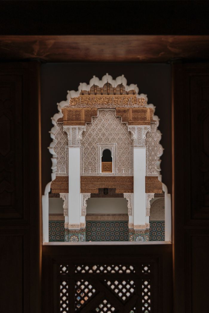services-07 Captivating view of intricate Middle Eastern facade through an embellished archway.