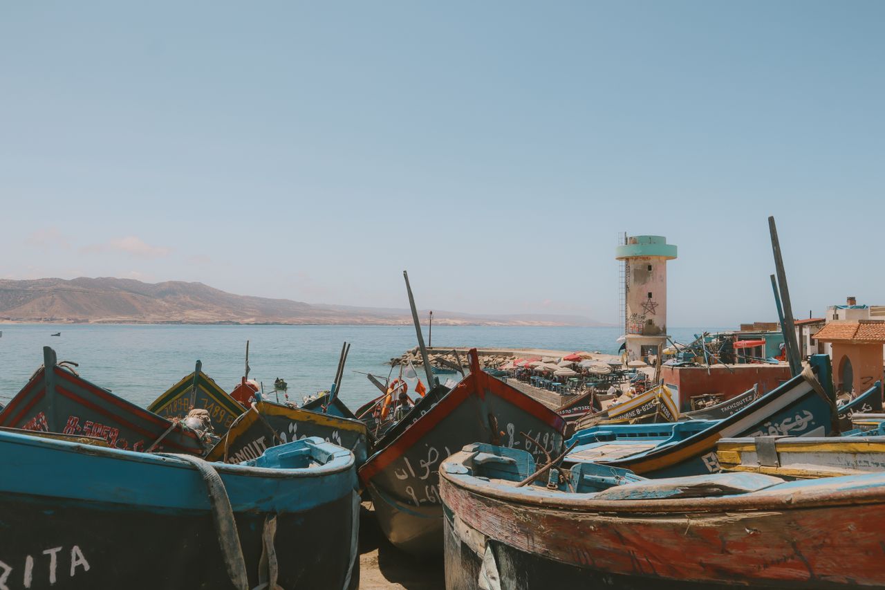 Vibrant fishing boats along the picturesque coast of Imsouane, Morocco.