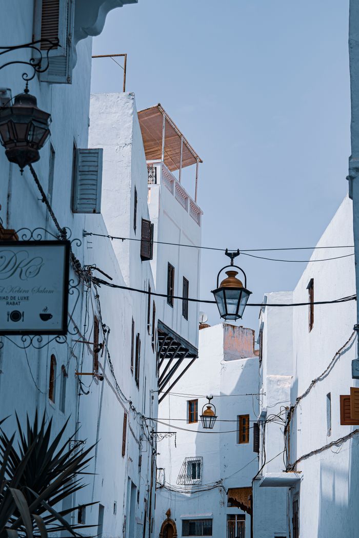 services-05 Beautiful alley with traditional Moroccan architecture and decorative lanterns in a historic city.