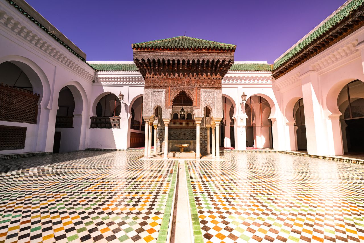 Stunning Moroccan courtyard showcasing traditional architecture and colorful tile patterns.