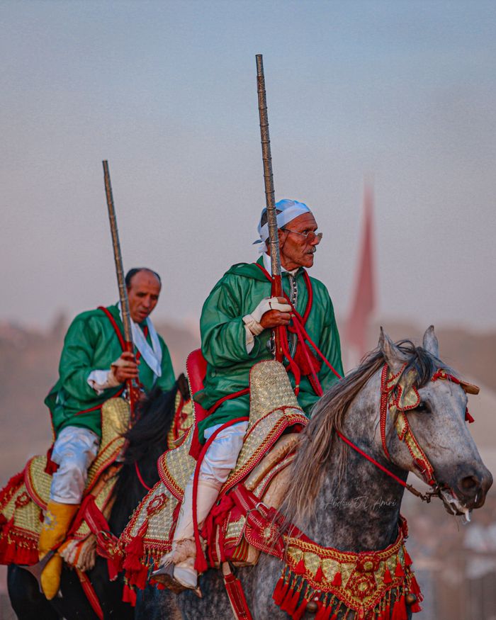Colorful display of traditional Moroccan horsemen in a festival parade, showcasing cultural heritage.