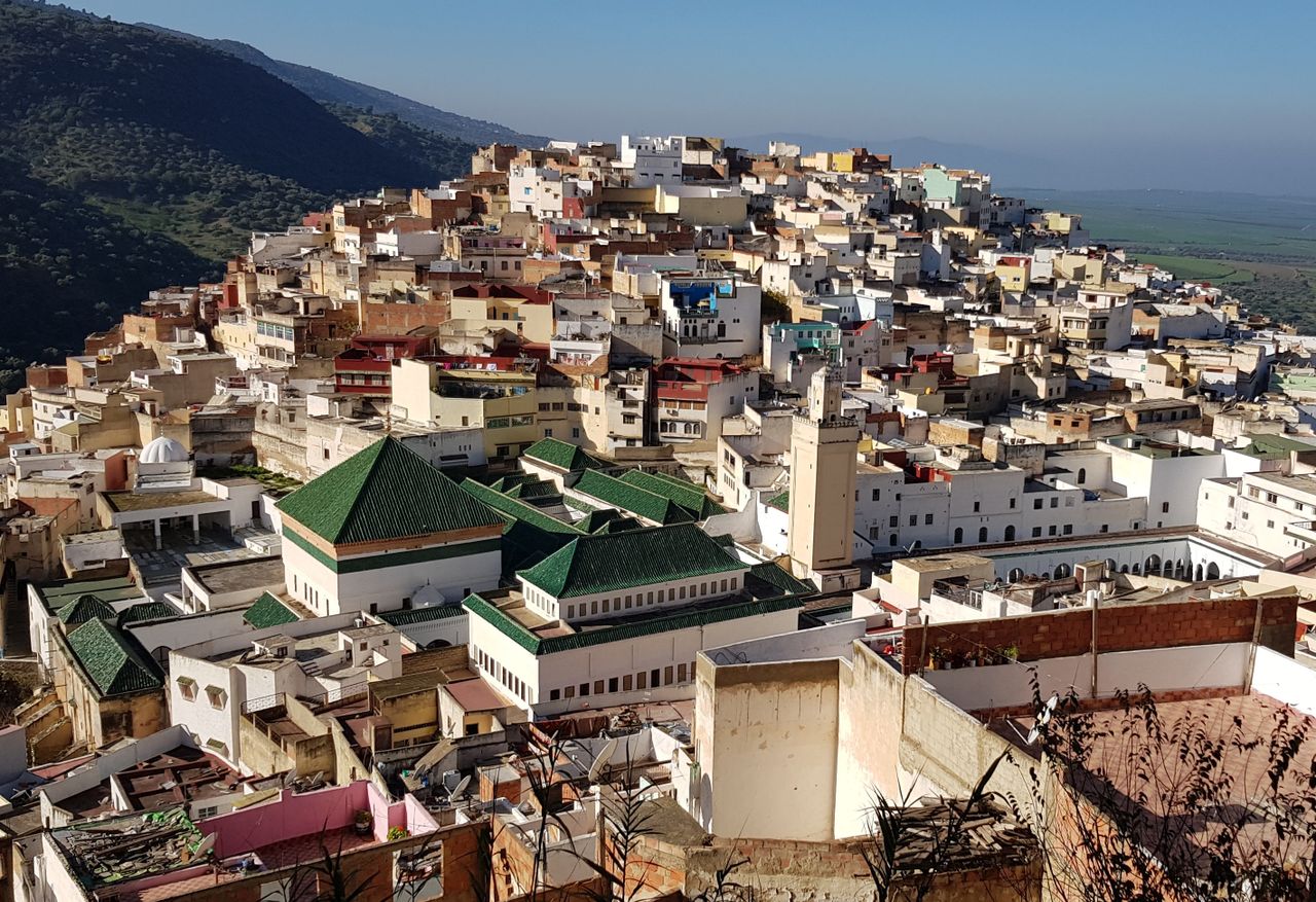 Stunning aerial view of Tangier, showcasing traditional Moroccan architecture against a scenic hillside backdrop.